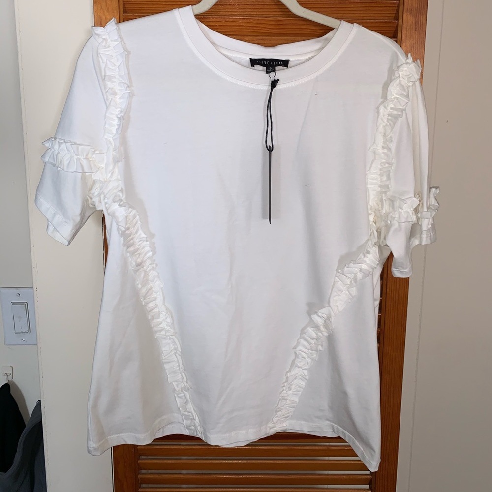 Loose fitting short sleeve tee with ruffles.